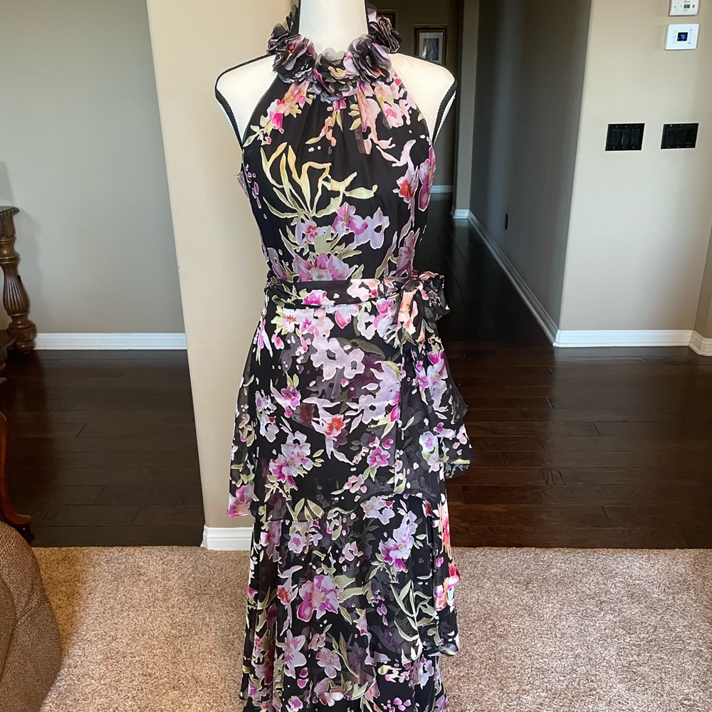 Floor length high collared dress with tie around waist.